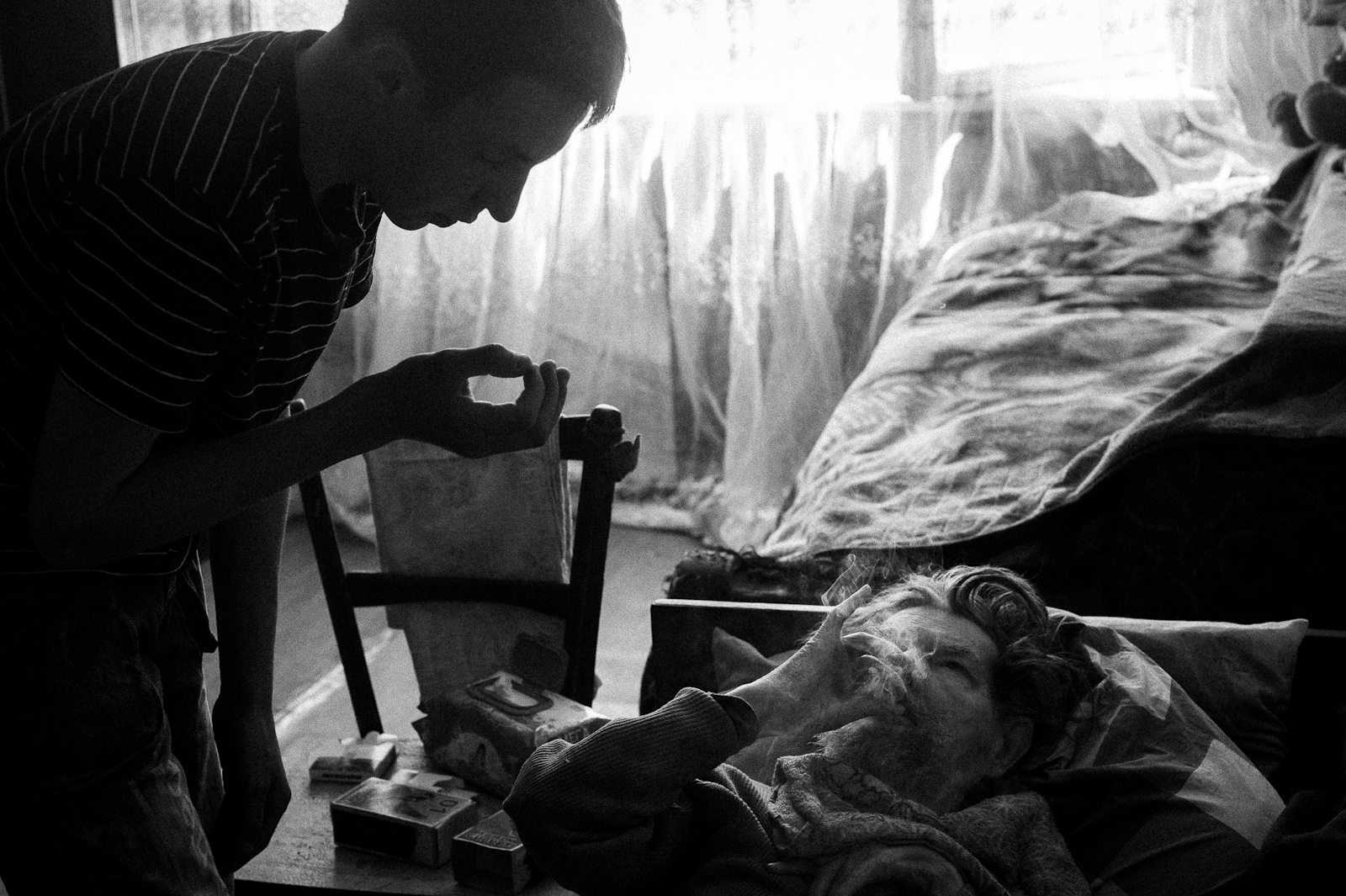 Arik Shraga. "Joint" Families: The Stories of Love. Almaty. Artem and his grandfather Artem’s grandfather is bed bound and last 9 years he is being taken care of by his grandson. All these years Artem’s mother was around but never cared of neither her dad nor her son. Afterwards she died of alcohol abuse.