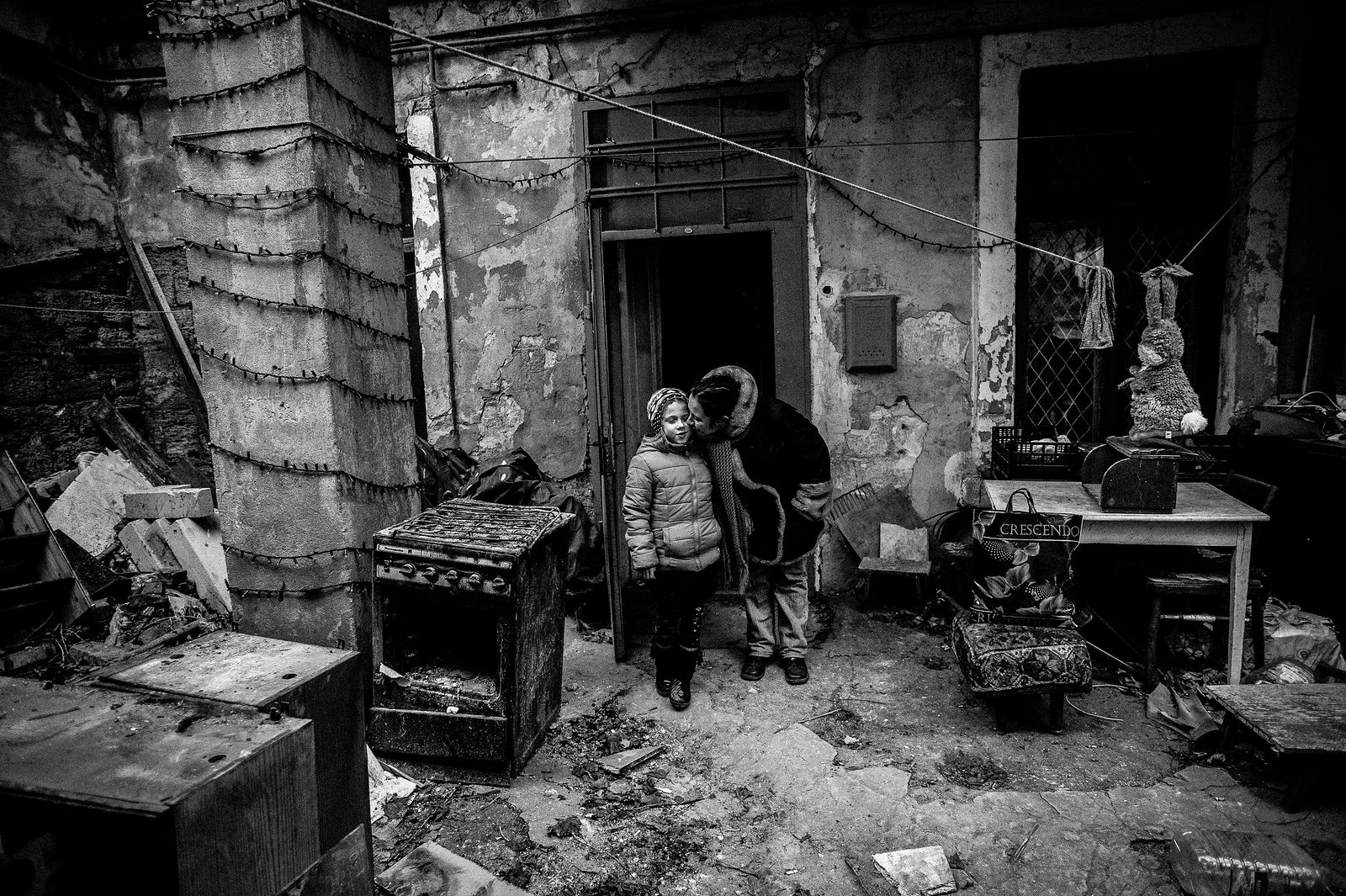 Arik Shraga. Humanitarian Photography. 2013. Ukraine, Odessa. Lera and her mother Lera’s life which began as a disaster gets constantly saved by people who love her. She was born deaf, and doctors didn’t see any chances for improvement. Thanks to efforts of her family and financial support of JDC she got a high-end hearing device and special training from a speech specialist. Now she is not just capable of hearing and speaking but she studies at a regular school, acts at a theatre and often gets all sorts of awards for her numerous talents.
In 2013 a tiny flat where Lera lives with her family caught on fire. Her father was severely injured, and the flat became unsuitable for residing in it.
See next picture to know how the situation changed in 3 years after that.