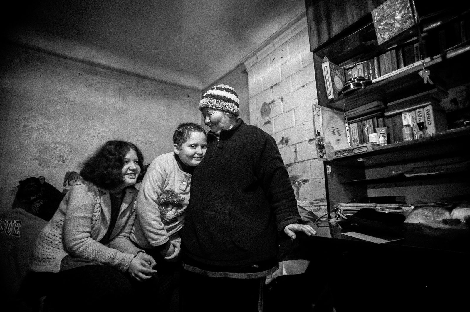 Arik Shraga. "Joint" Families: The Stories of Love. Makar family The children’s mother was deprived of parental rights and disappeared. The grandmother took over. She shares her only tiny, dark room located on a basement floor. Although it’s now too packed, the grandmother is happy to take care of the kids.