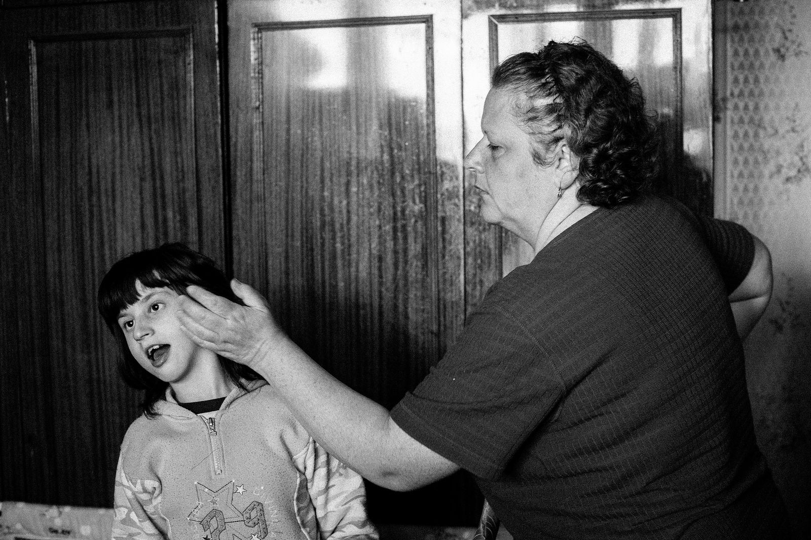 Arik Shraga. "Joint" Families: The Stories of Love. Kiev. Tanya with her mother Tanya was born with cerebral palsy and lives in one tiny room with her lonely mother. The two couldn’t live without each other.