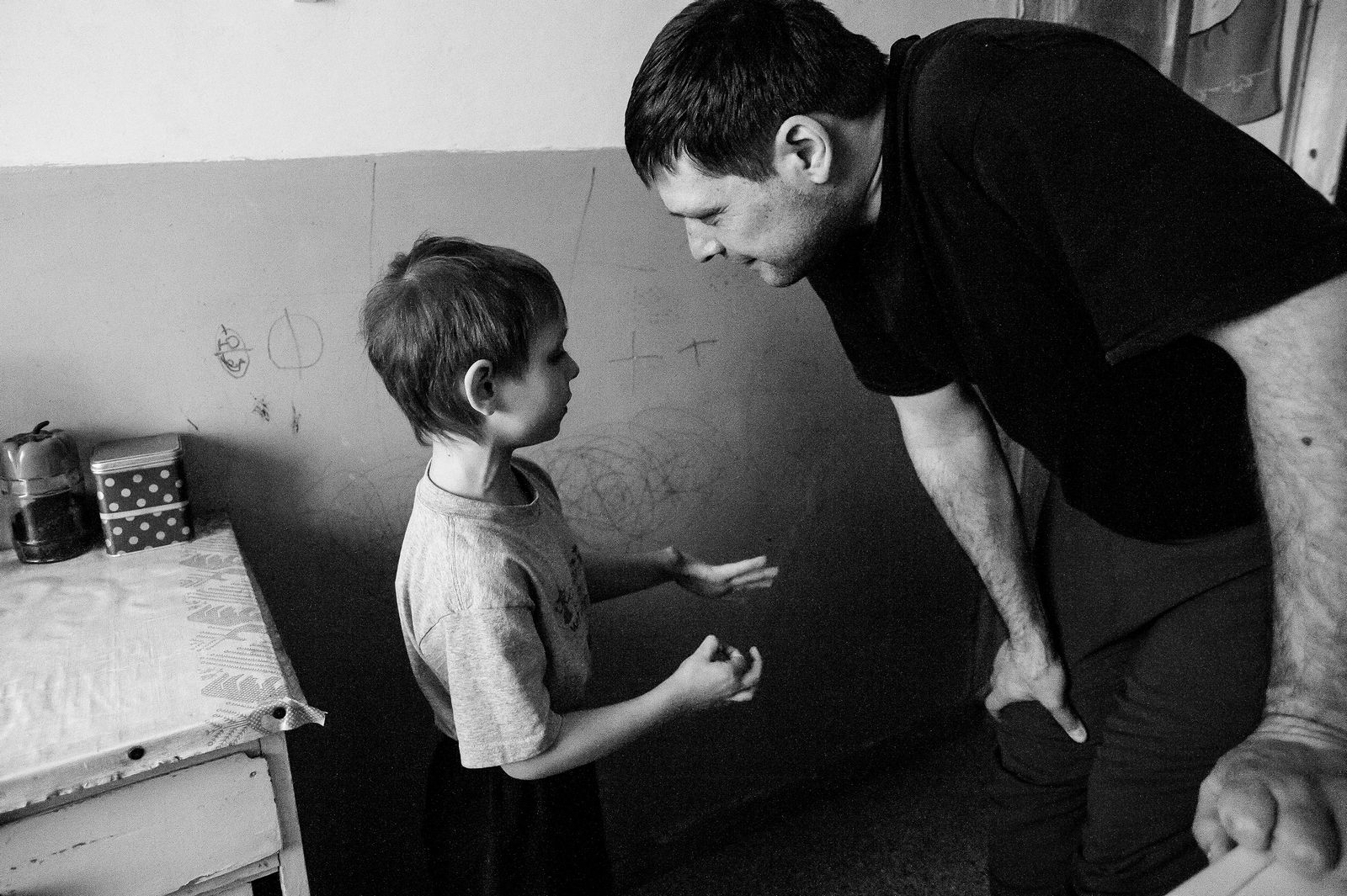 Arik Shraga. "Joint" Families: The Stories of Love. Kharkov. Andrey with his son Looking at kind, joyful, full of energy face of Andrey it’s hard to imagine that this young guy suffers all the time from pain in his spine and bands. He was diagnosed with Ankylosing Spondylitis in childhood. The only way of treatment in his case is receiving painkillers daily. Without these medicines he’s unable to move.
Being dependant on the medicines Andrey was heavily affected by recession in Ukraine which led to dramatic prices rise. Some medicines now cost 2-10 times as much as they used to before the crisis.
Andrey can work only part-time, as a network administrator, and gets salary of around 40 USD per month. Another 30 USD he gets as a state disability allowance.
With this money he is supposed to support himself and his family which includes wife and 6 years old kid.