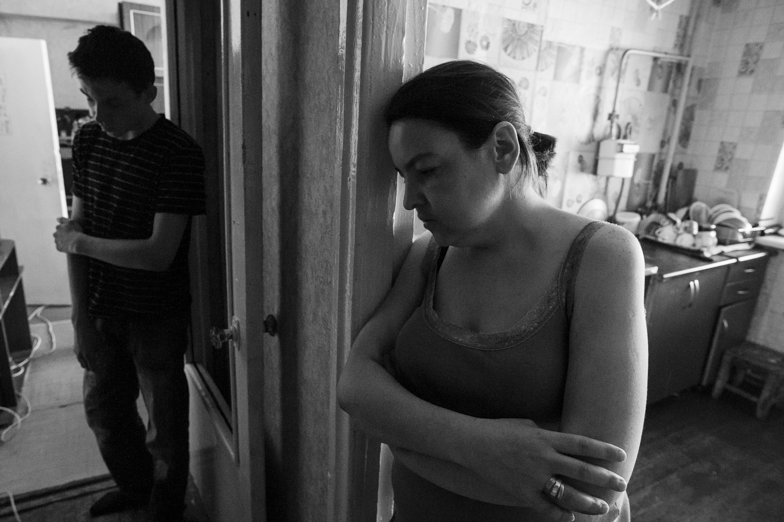 Arik Shraga. Kazakhstan. Almaty. Artem Artem is 14 but all home duties are on his shoulders. He also takes care of his bed bound grandpa. He is with his mother on this picture. She is alcoholic. A month after this shot was taken she died.