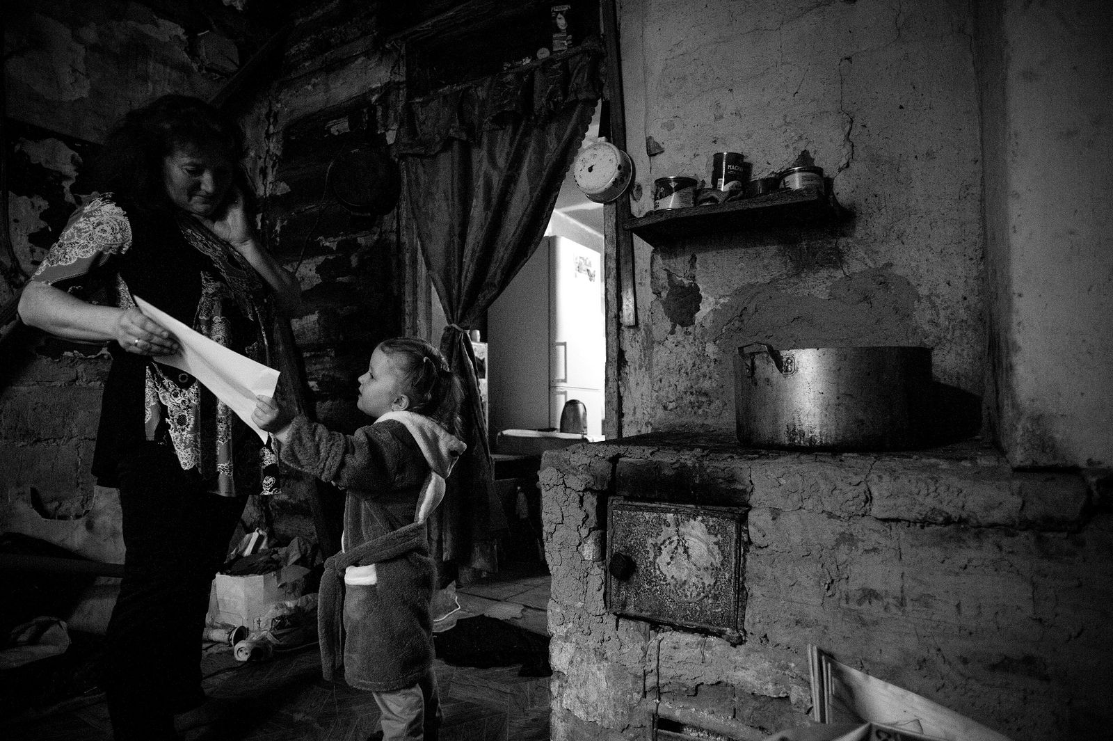 Arik Shraga. Russia. Ural region. Cheljabinsk. Polina with her mother Little Polina resides with her parents in a falling apart house. Local authorities planned to demolish it back in 1980s but it never happened
